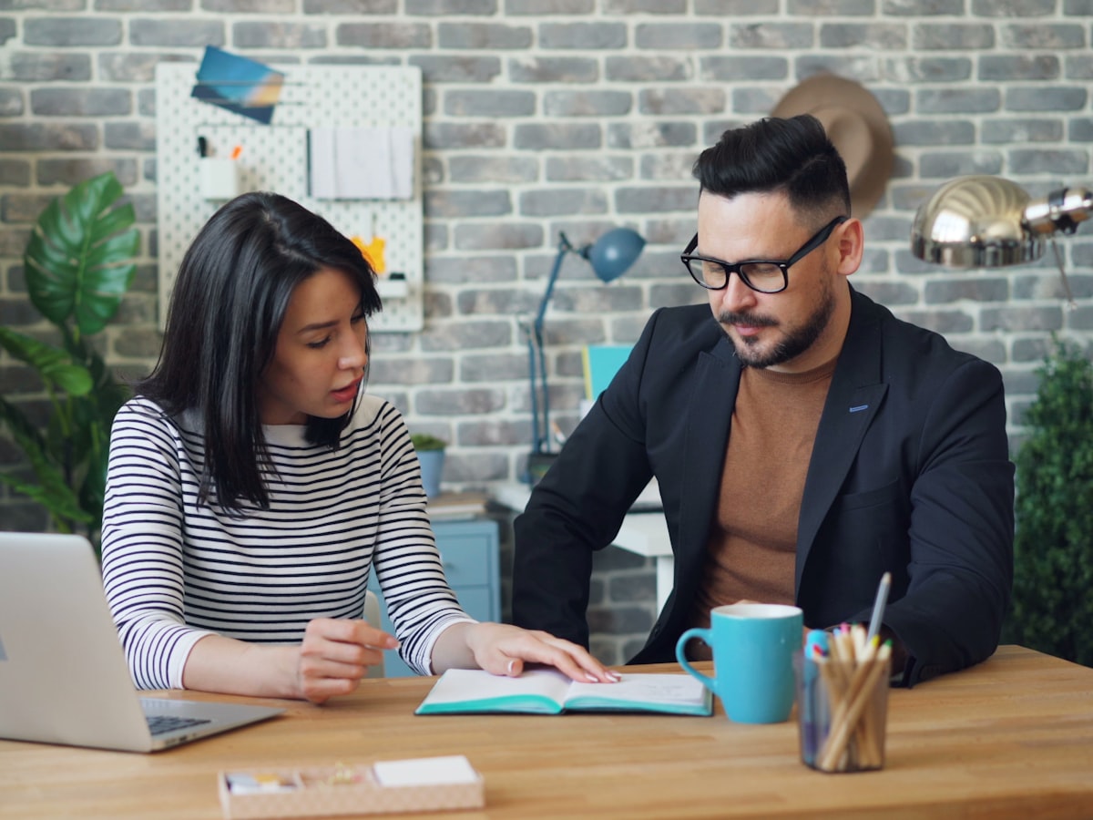 Two DataView Analytics colleagues reviewing work together in a city office