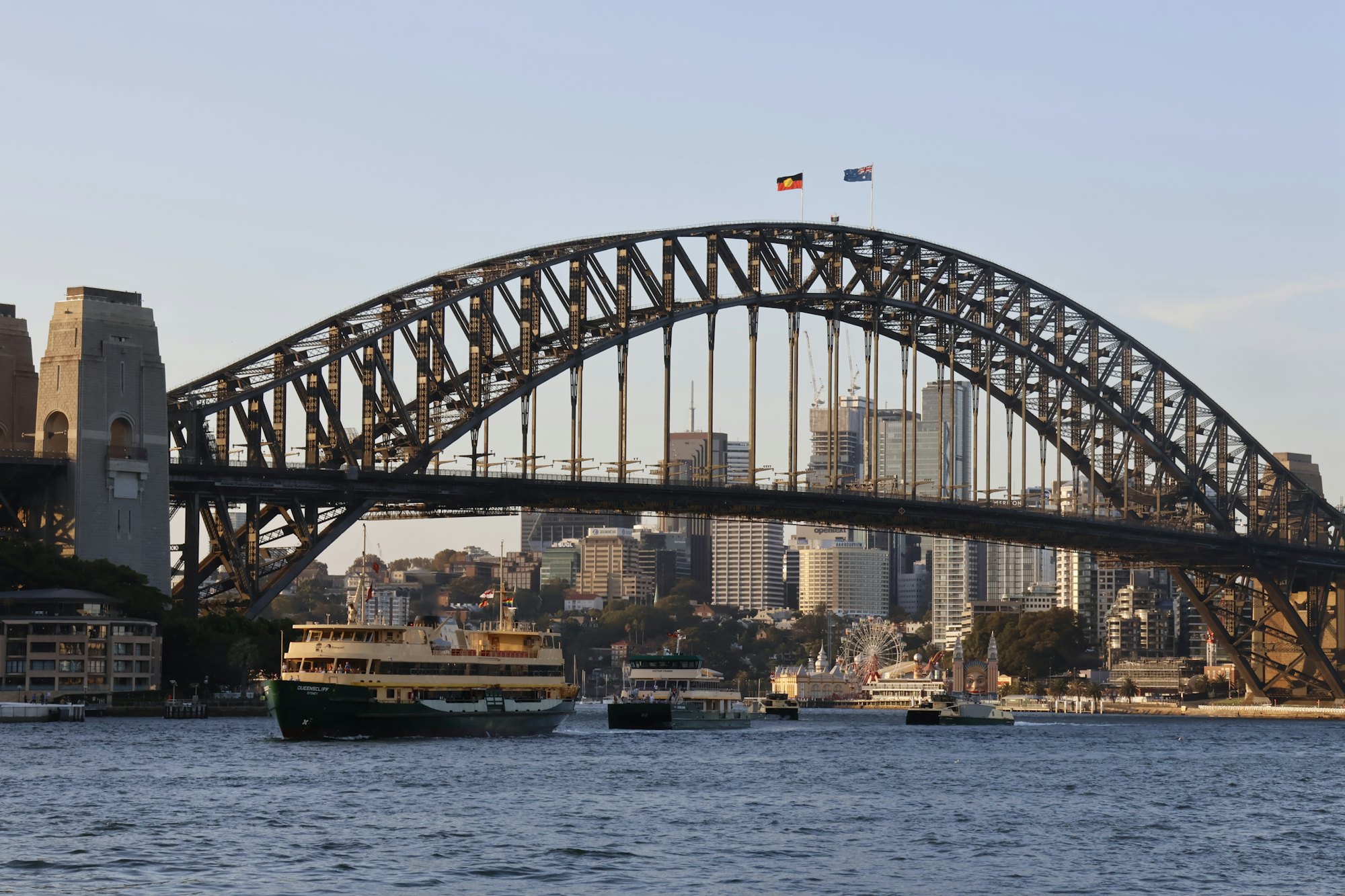 Sydney Harbour Bridge and city skyline with the Australian and Aboriginal flags flying